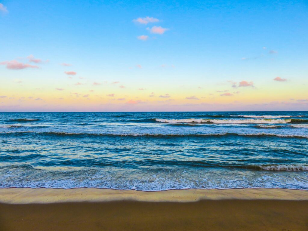 Peaceful ocean waves at sunset, a perfect seascape for relaxation.
